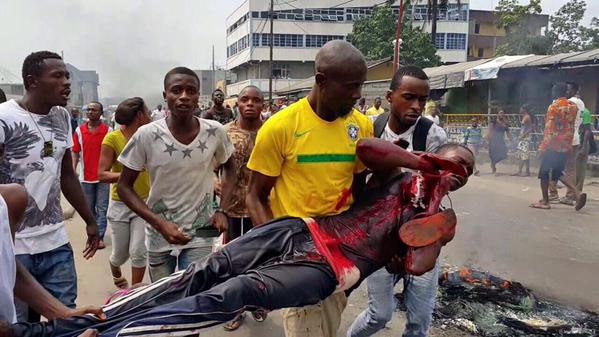 Protesters carry an injured colleague in the latest spate of violence in Kinshasa (Courtesy photo) 