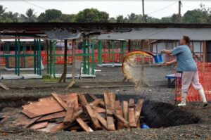 A Doctors Without Borders agent prepares to burn pieces of a dismantled tent on January 27, 2015 after the first section of the ELWA III Ebola Management Center in Monrovia was decomissioned (AFP Photo/Zoom Dosso)