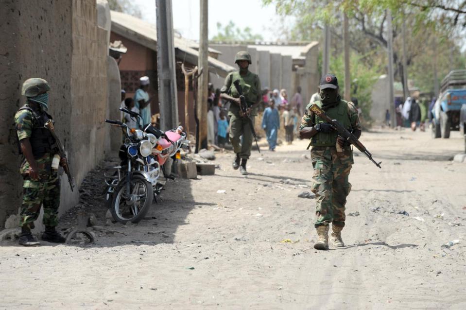 Soldiers walk on April 30, 2013 in the street in the remote northeast town of Baga, Borno State (AFP Photo/Pius Utomi Ekpei)