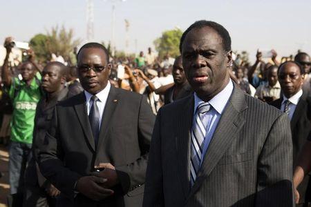 Burkina Faso President Michel Kafondo (R) and Prime Minister Isaac Zida (L) arrive at a memorial service for six people who died during the recent popular uprising in Ouagadougou, December 2, 2014. REUTERS/Joe Penney