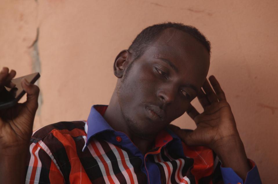 In this photo taken Thursday, Jan. 29, 2015, Somalian, Salat Abdullahi, talks with the Associated Press, in what is known as Little Mogadishu in Johannesburg. Abdullahi is living in temporary quarters after he was barricaded inside the shop that he worked and slept in, in Soweto, while looters threatened him from outside during unrest and looting in the township south west of Johannesburg. (AP Photo/Denis Farrell)