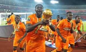 Ivory Coast's Kolo Touré raises the trophy after the final. Photograph: Carl De Souza/AFP/Getty Images 