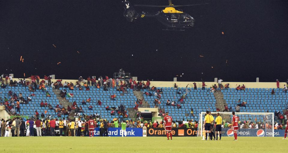 A police helicopter was required to disperse fans during the crowd violence that marred Equatorial Guinea’s match against Ghana. Photograph: Li Jing/Xinhua Press/Corbis