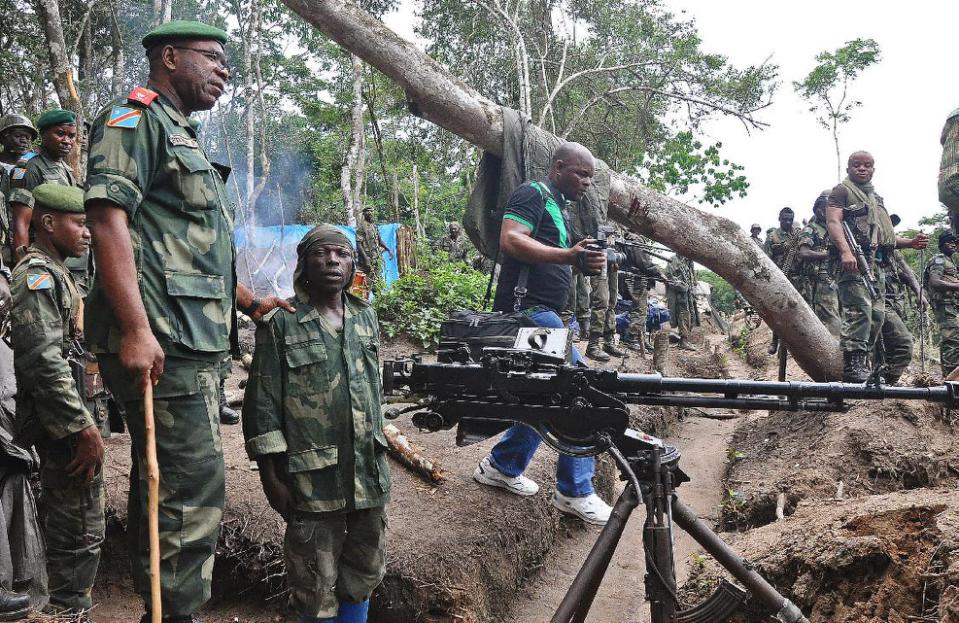 Lieutenant General Didier Etumba Longila (left), chief of the general staff of DR Congo armed forces, meets soldiers in Beni in North Kivu, in May last year (AFP Photo/)