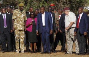 Kenya's President Uhuru Kenyatta (C) looks on as 15 tonnes of ivory confiscated from smugglers and poachers is burnt to mark the World Wildlife Day at the Nairobi National Park March 3, 2015. The United Nations on December 20, 2013, declared 3rd March World Wildlife Day as a celebration of wild fauna and flora and to raise awareness of illegal trade. The 2015 theme for World Wildlife Day is "Wildlife Crime is serious; let's get serious about wildlife crime". REUTERS/Thomas Mukoya (KENYA - Tags: SOCIETY CRIME LAW POLITICS ANNIVERSARY ENVIRONMENT ANIMALS) 