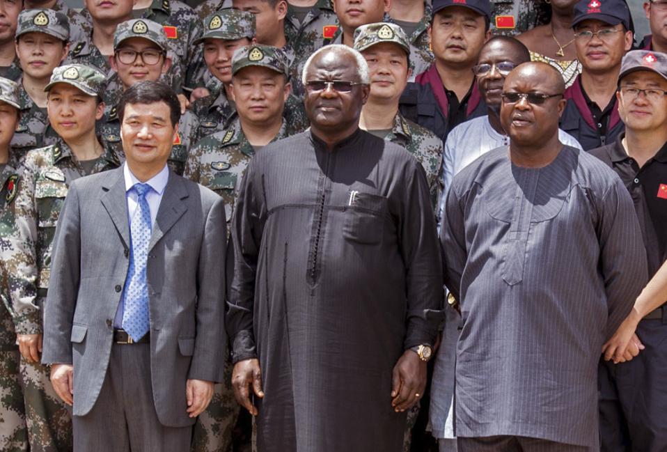 In this photo taken on Sept. 25, 2014, Chinese Ambassador Zhao Yanbo, center left, stands next to Sierra Leone's President Ernest Bai Koroma, center, and Sierra Leone's Vice President Samuel Sam-Sumana, centre right, during the opening ceremony of the China Friendship Hospital catering for Ebola virus patience in Freetown, Sierra Leone. Sierra Leone's vice president has put himself in quarantine following the death from Ebola of one of his security guards. Sam-Sumana voluntarily decided to quarantine himself for 21 days following the death from Ebola last Tuesday Feb. 24, 2015, of one of his security personnel, according to a report issued late Saturday, Feb. 28, 2015, by the Sierra Leone Broadcasting Corporation. (AP Photo/ Michael Duff)