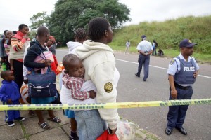 Foreign nationals are escorted to safety by members of the South African Police Service after a xenophobic attack in Durban on April 8, 2015 (AFP Photo/Rajesh Jantilal) 