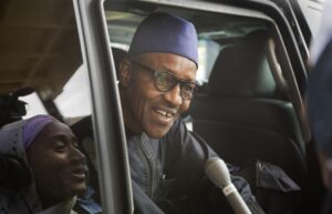 Nigerian opposition candidate Gen. Muhammadu Buhari speaks to reporters as he gets into his vehicle after signing a joint renewal with President Goodluck Jonathan of their pledge to hold peaceful "free, fair, and credible" elections, at a hotel in the capital Abuja, Nigeria Thursday, March 26, 2015. Nigerians are due to go to the polls to vote in presidential elections on Saturday. (AP Photo/Ben Curtis) 