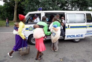 Members of the South African Police Service escort foreign nationals after a xenophobic attack in Durban on April 8, 2015 (AFP Photo/Rajesh Jantilal) 