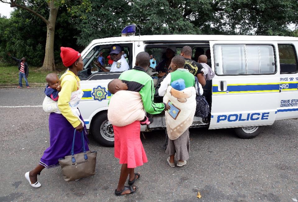 Members of the South African Police Service escort foreign nationals after a xenophobic attack in Durban on April 8, 2015 (AFP Photo/Rajesh Jantilal)