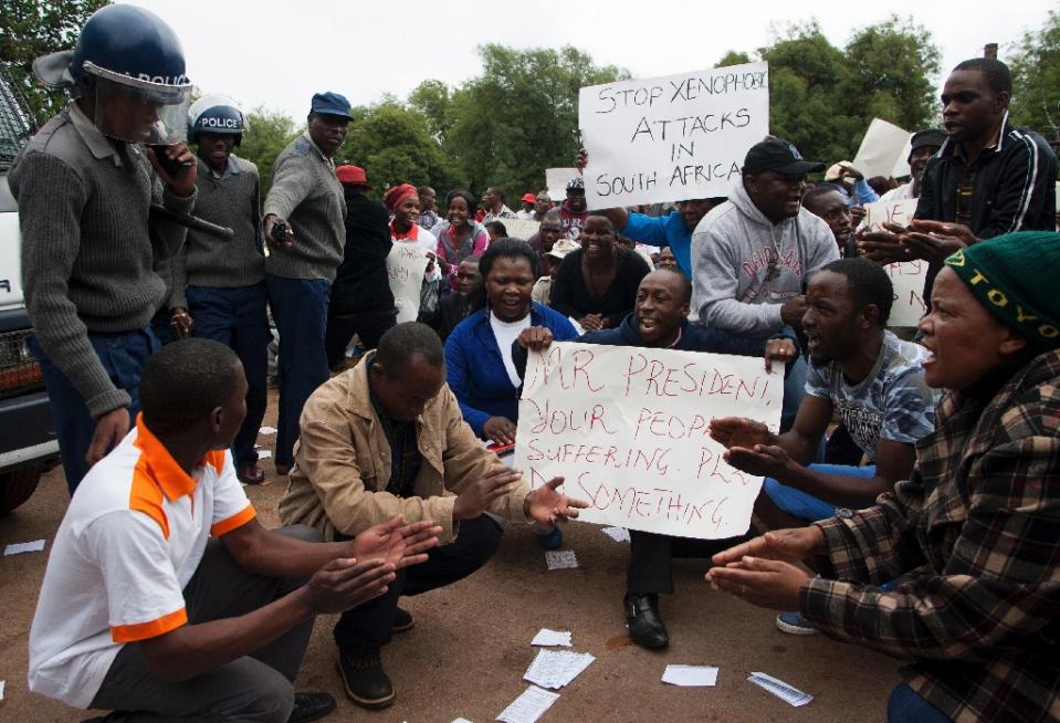 Zimbabwean citizens protest outside the South African Embassy in Harare, against a wave of violence against immigrants in parts of South Africa on April 17, 2015 (AFP Photo/Jekesai Njikizana)