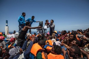 Picture taken on May 3, 2015 and released by the MOAS (Migrant Offshore Aid Station) shows migrants waiting aboard a wooden boat during a rescue operation off the coast of Sicily in the Mediterranean (AFP Photo/Jason Florio)