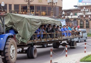 In this photo taken on May 20, 2015, Chinese workers travel on the back of a trailer pulled by a tractor on their way to work in Kinshasa, Democratic Republic of Congo. Congos government is bringing in outside experts including officials from the World Bank and the United Nations, to investigate the long-term impact of some $6.7 billion in contracts with Chinese companies that critics have said could exploit the central African nations mineral riches.(AP Photo/John Bompengo)