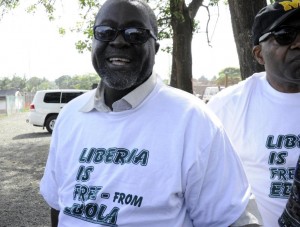 Liberian Information Minister Lewis Brown (L) wears a t-shirt reading "Liberia is free from Ebola" during the World Health Organization announcement of the end of Ebola in Liberia, on May 9, 2015 in Monrovia (AFP Photo/Zoom Dosso)