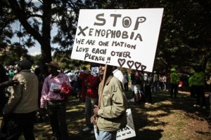 A demonstrator holds a banner in Johannesburg on April 23, 2015 during a march against xenophobia (AFP Photo/Gianluigi Guercia)