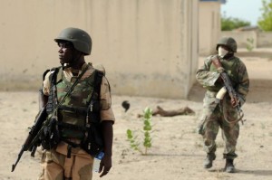 Nigerian soldiers patrolling in the north of Borno state close to a Islamist extremist group Boko Haram former camp near Maiduguri, northeast Nigeria on June 5, 2013 (AFP Photo/Quentin Leboucher)