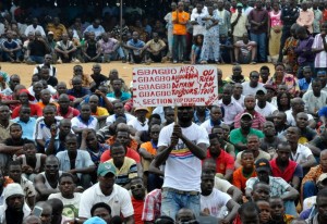 People attend the first rally of the opposition National Coalition for Change on June 20, 2015 in the Yopougon district of Abidjan, with a sign reading "Gbagbo yesterday, today, tomorrow, for ever", refering to former president Laurent Gbagbo (AFP Photo/Sia Kambou) 