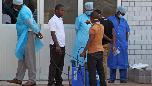 In this photo taken on Saturday, March 29, 2014, medical personnel at the emergency entrance of a hospital receive suspected Ebola virus patients in Conakry, Guinea.  AP . Besides fighting Ebola, Guinea is overhauling its health care system and infrastructure