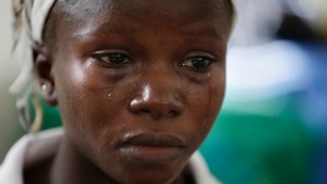 In this photo taken on Aug. 11, Ebola survivor Victoria Yillia cries as she recalls her family members who died of Ebola. She delivered her child just a few minutes' walk from the ward where just last year she had hovered between life and death. (Sunday Alamba/Associated Press)