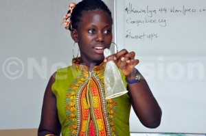 Facilitator Priscilla Nabatazi demonstrates how the female condom is used during media and sexuality training at Eureka Place Hotel in Kampala on Friday Sept 4, 2015. Photo by Francis EmorutParticipants examining the female condoms during media and sexuality training at Eureka Place Hotel in Kampala on Friday Sept 4, 2015. Photo by Francis Emorut