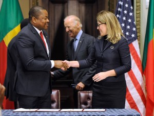 Benin Minister of Finance Komi Koutche, left, and MCC CEO Dana J. Hyde, right, shake hands after signing the $375 million Benin Power Compact in the presence of Benin President Dr. Thomas Boni Yayi, not shown, and U.S. Vice President Joe Biden, center, Wednesday, Sept. 9, 2015, in Washington.