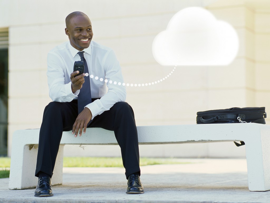 businessman sitting on a bench holding a mobile phone