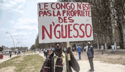 n this file picture taken on September 27, 2015 a man holds a placard reading "Congo is not the property of N'Guesso" during an opposition demonstration in Brazzaville. PHOTO | AFP