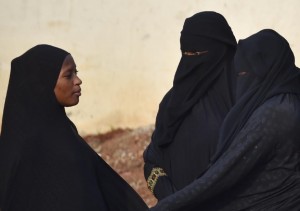 Full-face veils including the niqab, worn by the two women at right in this July 23, 2015 photo from Abidjan, capital of the Ivory Coast, would be barred from wearing such veils in member states of ECOWAS if proposed new bans are enacted (AFP Photo/Issouf Sanogo)