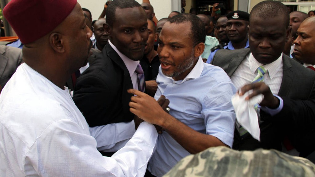 Director of Radio Biafra, Nnamdi Kanu, sandwiched between security operaives, leaving the court in Abuja recently