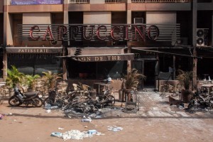 Debris outside the Cappuccino cafe Monday, Jan. 18, 2016, after militants led an attack on a hotel and a cafe popular with foreigners over the weekend in Ouagadougou, Burkina Faso. In the wake of the attack that left over 30 dead, security was beefed up across Burkina Faso's capital Monday as businesses and banks reopened. The West African nation also announced a joint effort with Mali in the fight against jihadi elements in the West African region. (AP Photo/Theo Renaut)