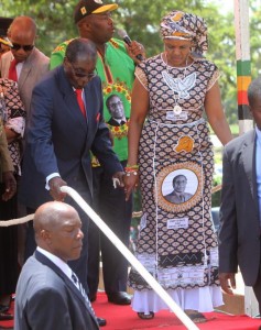 Zimbabwean President Robert Mugabe, left, is assisted by his wife Grace to get off the stage after addressing supporters at the party headquarters in Harare, Wednesday Feb, 10, 2016. Mugabe addressed thousand of party supporters and chaired a bitterly divided Zanu pf Politiburo amid heightened tensions over issues to do with factionalism and succession in the party.(AP Photo/Tsvangirayi Mukwazhi)