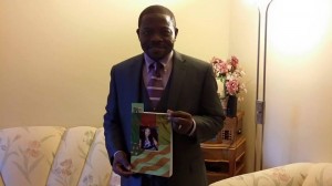 Oliver Asaah with a copy of the Broken Bond.Copies of the book will be on sale at the album launch