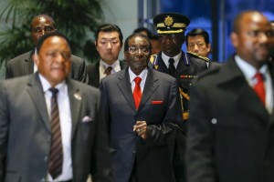 Zimbabwean President Robert Mugabe (C), pictured arriving for talks with Japanese Prime Minister Shinzo Abe in Tokyo on March 28, says he is still popular in his home country. KIMIMASA MAYAMA/AFP/GETTY IMAGES