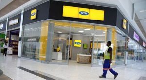 A worker walks past an outlet of South Africa's MTN Group in Johannesburg, South Africa, February 23, 2016. REUTERS/Siphiwe Sibeko/File Photo