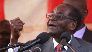 Zimbawe's president, Robert Mugabe, gestures as he addresses supporters of his ruling ZANU-PF party at Harare International Airport, Zimbabwe, Sept. 24, 2016