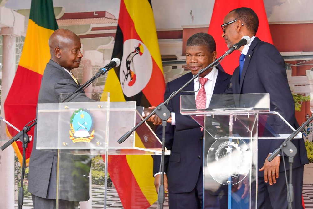 President Museveni (left) shaking hands with Kagame (right) after signing while João Lourenço looks on