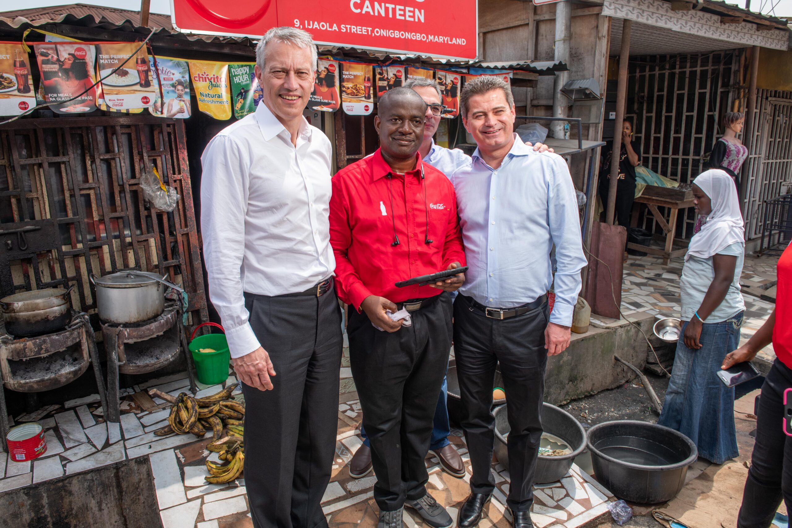 James Quincey, Chairman & CEO The Coca-Cola Company, a Nigeria Bottling Company Sales Representative and Zoran Bogdanovic, Coca-Cola Hellenic CEO during a market visit at Maryland in Lagos
