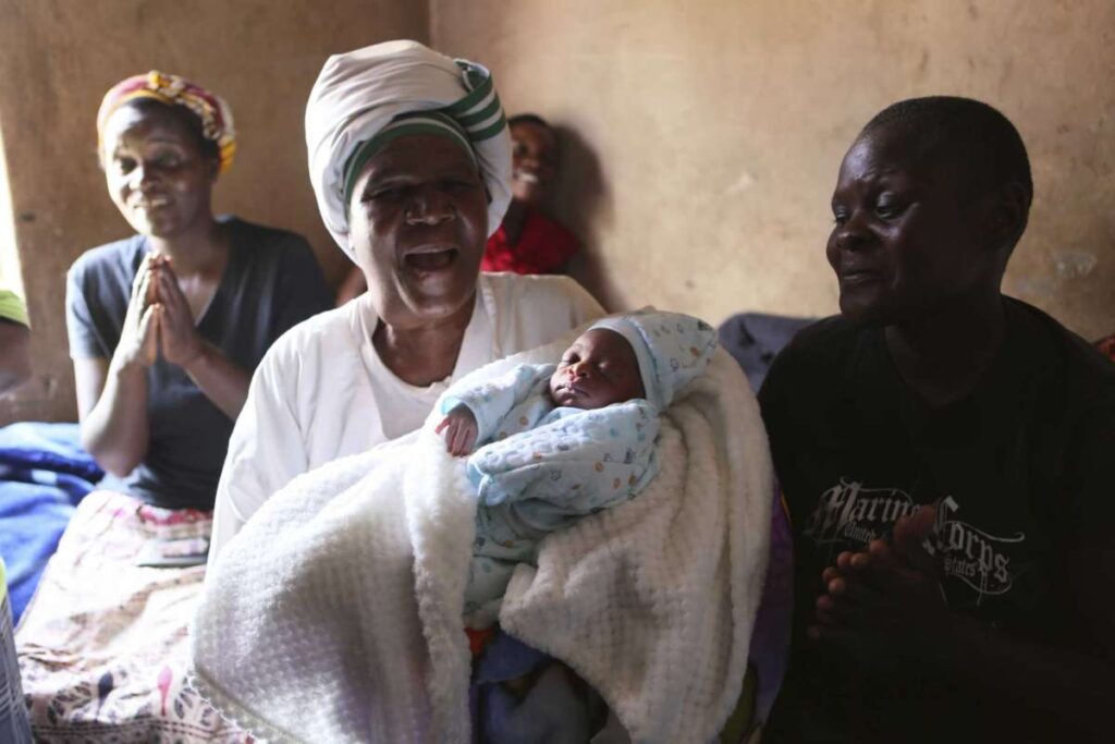 Esther Zinyoro Gwena holds one of the babies she has just delivered in her tiny apartment in the poor suburb of Mbare in Harare, Zimbabwe, Saturday, Nov. 16, 2019.Photo: Tsvangirayi Mukwazhi, AP