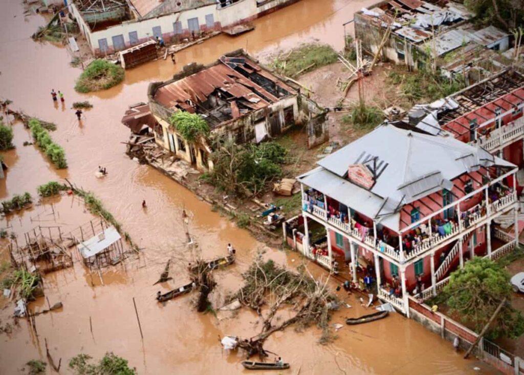 People walk on the flooded street of Buzi, central Mozambique, on 20 March 2019 after the passage of the cyclone Idai. - International aid agencies raced on 20 March to rescue survivors and meet spiralling humanitarian needs in three impoverished countries battered by one of the worst storms to hit southern Africa in decades. Five days after tropical cyclone Idai cut a swathe through Mozambique, Zimbabwe and Malawi, the confirmed death toll stood at more than 300 and hundreds of thousands of lives were at risk, officials said. Photo: AFP/Adrien Barbier