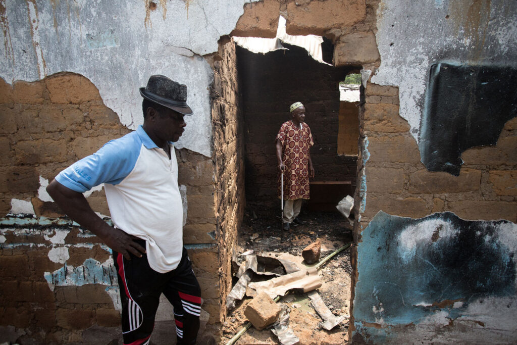 A village elder stands in what was once his bedroom in Eshobi on Feb. 11 as he describes how the Cameroon military came and destroyed it.Photo Credit FP Magazine