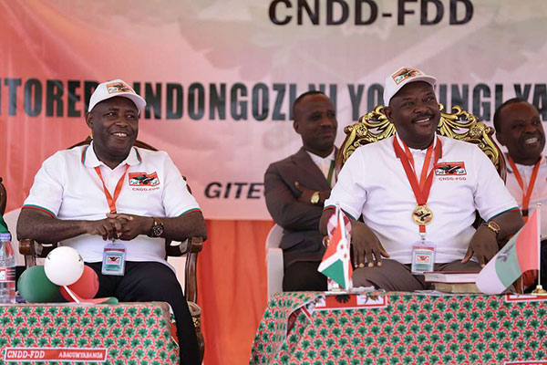 General Evariste Ndayishimiye (L) sits next to incumbent president of Burundi, Pierre Nkurunziza on January 26, 2020 at Gitega, central Burundi, during the ruling party CNDD-FDD's congress to nominate it's presidential candidate for the upcoming presidential elections in 2020. PHOTO | STRINGER | AFP 