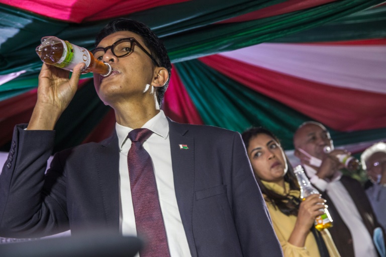 President Andry Rajoelina of Madagascar drinking a sample of Covid Organics which is making waves as a cure for coronavirus