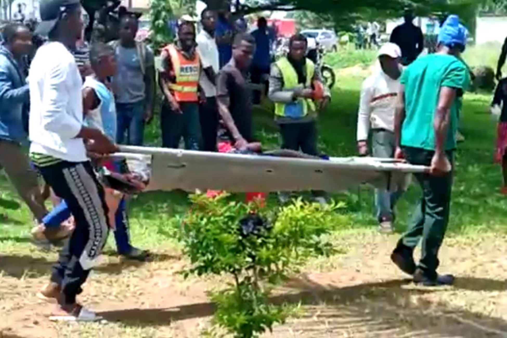 Body of a victim is carried following a shooting at a school in Kumba, Cameroon [Tamfu Ciduan Ndimbie/My Media Prime TV/via Reuters]